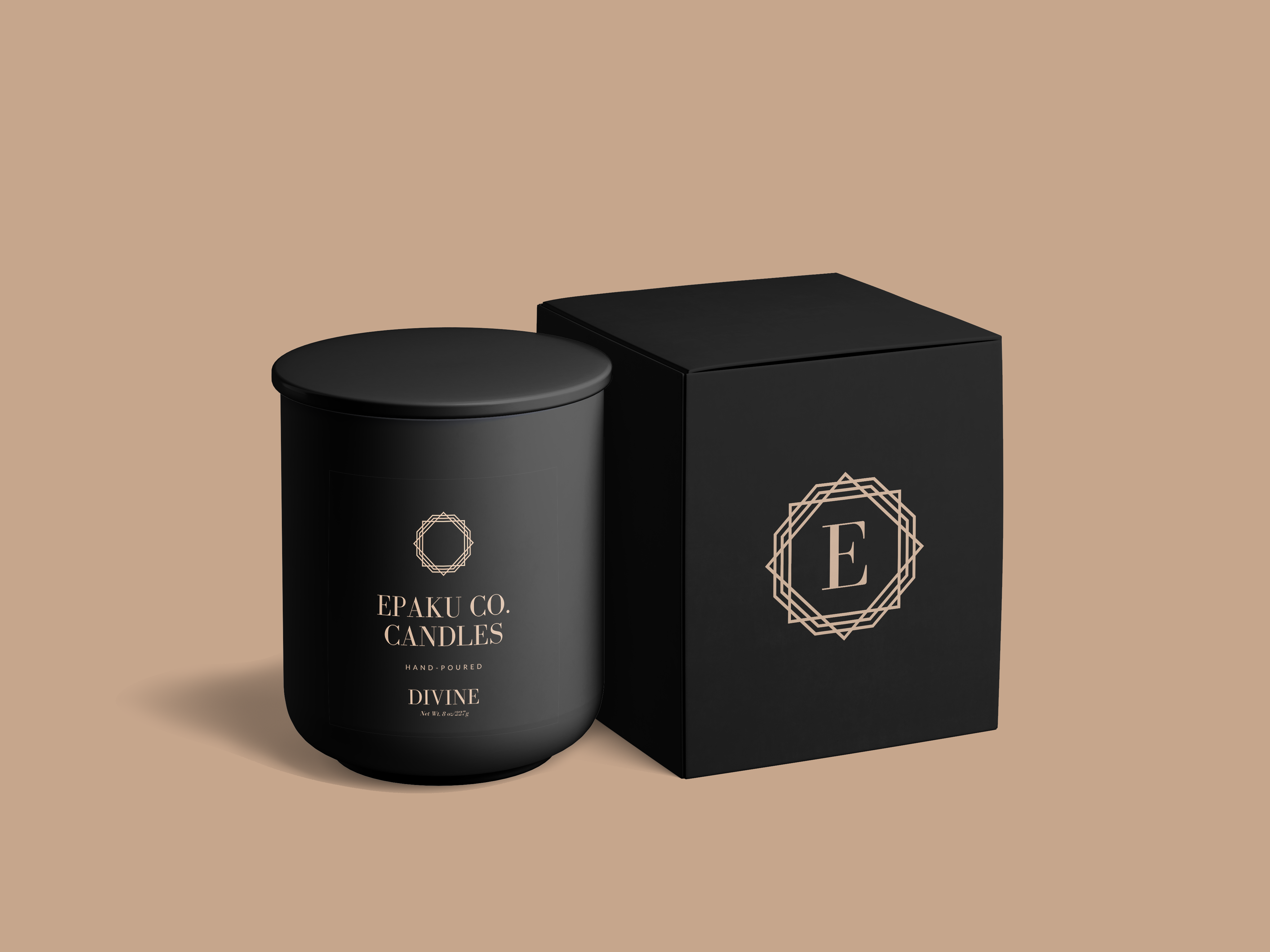 All black candle vessel with Black box. Box is embelleshed with a golden symbol, that has an E in the middle of the symbol. All of this is on a golden beige background