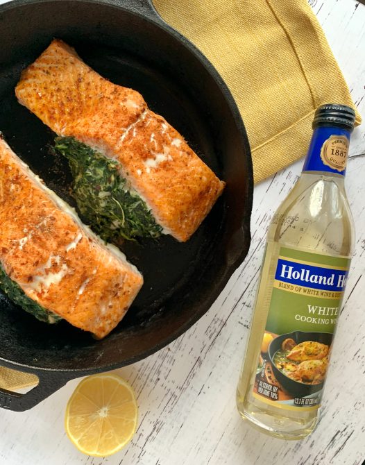 spinach stuffed salmon in a cast iron skillet