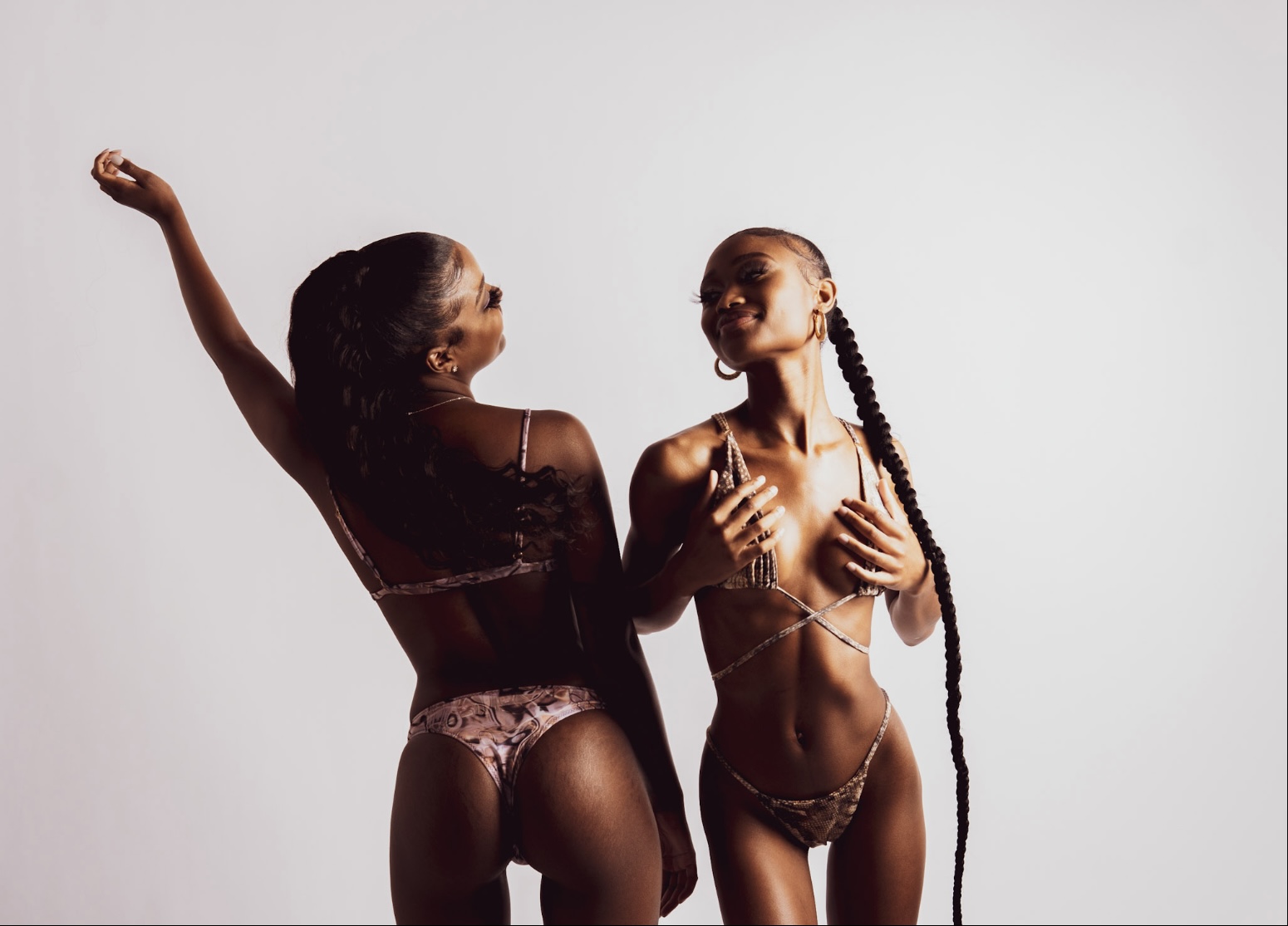 two models in lba swimwear. one in lba clothing's ripple effect bikini. one in lba clothing's snakeskin bikini