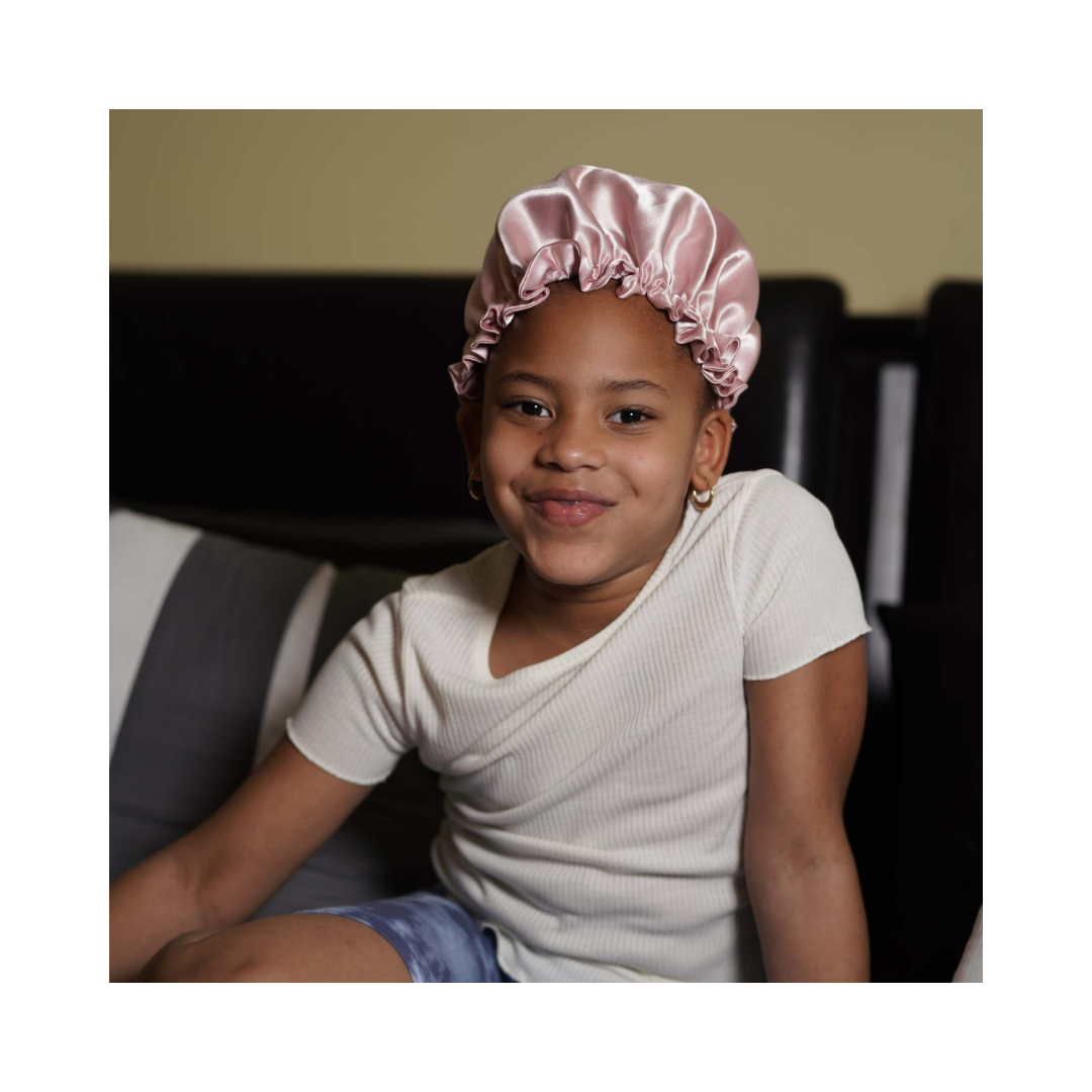 A child wearing the Artis Styling Satin Adjustable Bonnet