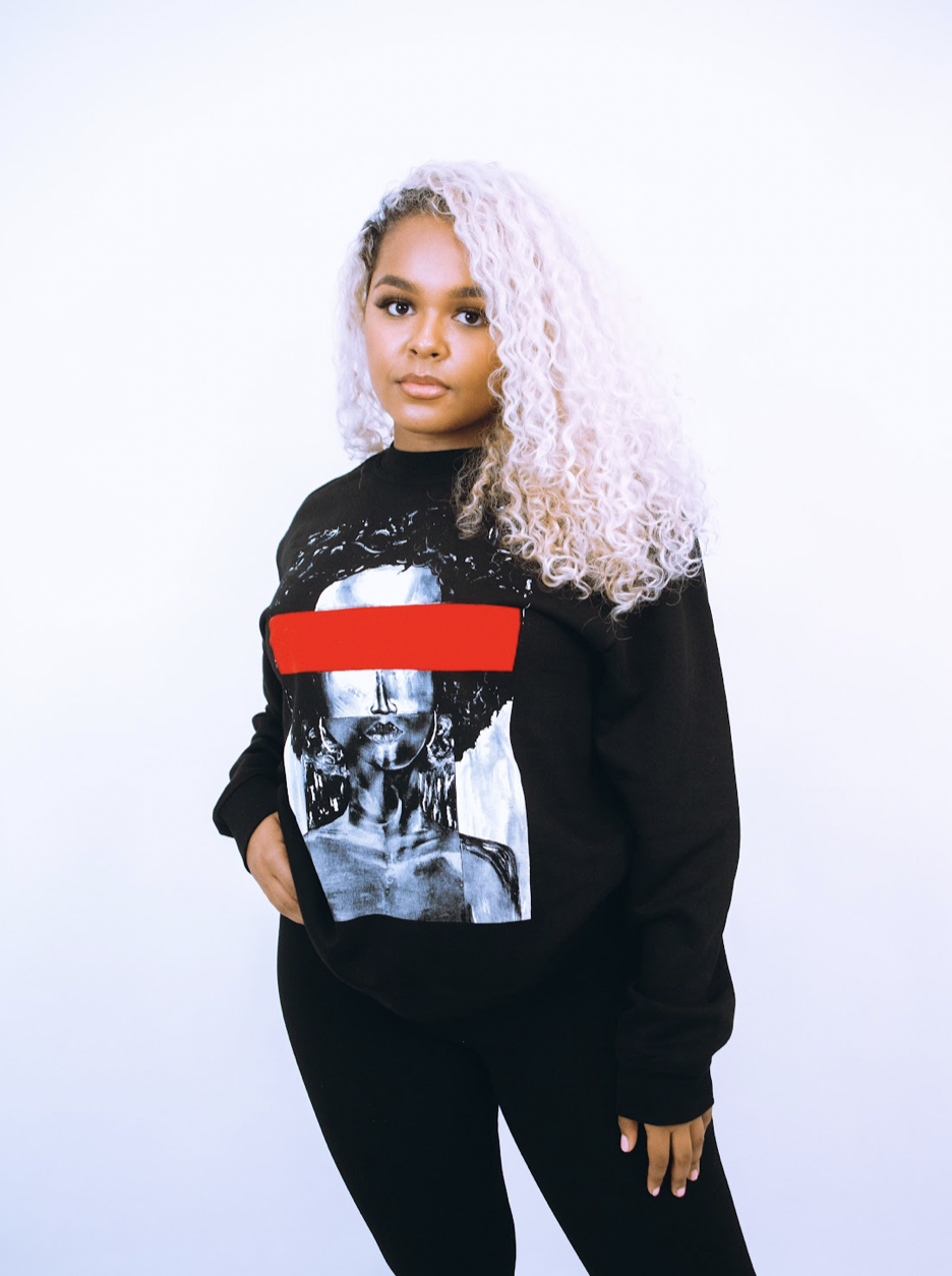 Female wearing Black sweatshirt with monochrome design and red feature