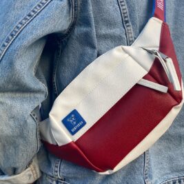 Vegan leather red and white crossbody bag that can be worn as on the chest bag, waist bag, or shoulder bag.
