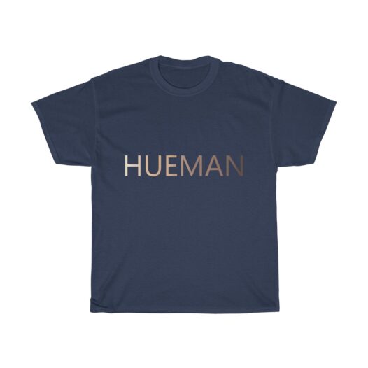 Picture of a navy blue t-shirt with the word Hueman on it that is skin-colored hues from dark skin tones to light skin tones.