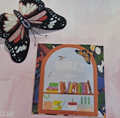 A printed example of one of my digital bookmarks with a small artificial butterfly in the top left corner of the sample