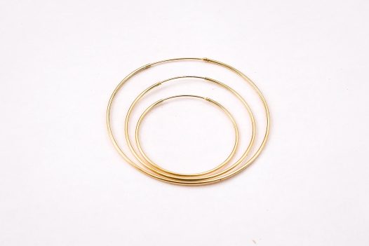Three size comparison of the 14k gold Amor Deus Gold Classic Hoop Earrings.