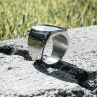 Silver Amor bold mens ring on concrete