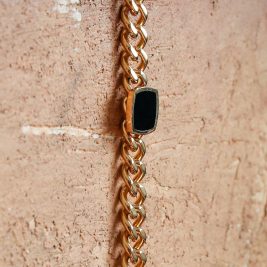 Onyx Bracelet laying flat down a wall