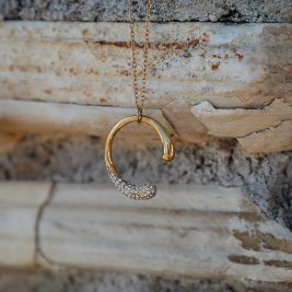Time to shine necklace against a stone backdrop