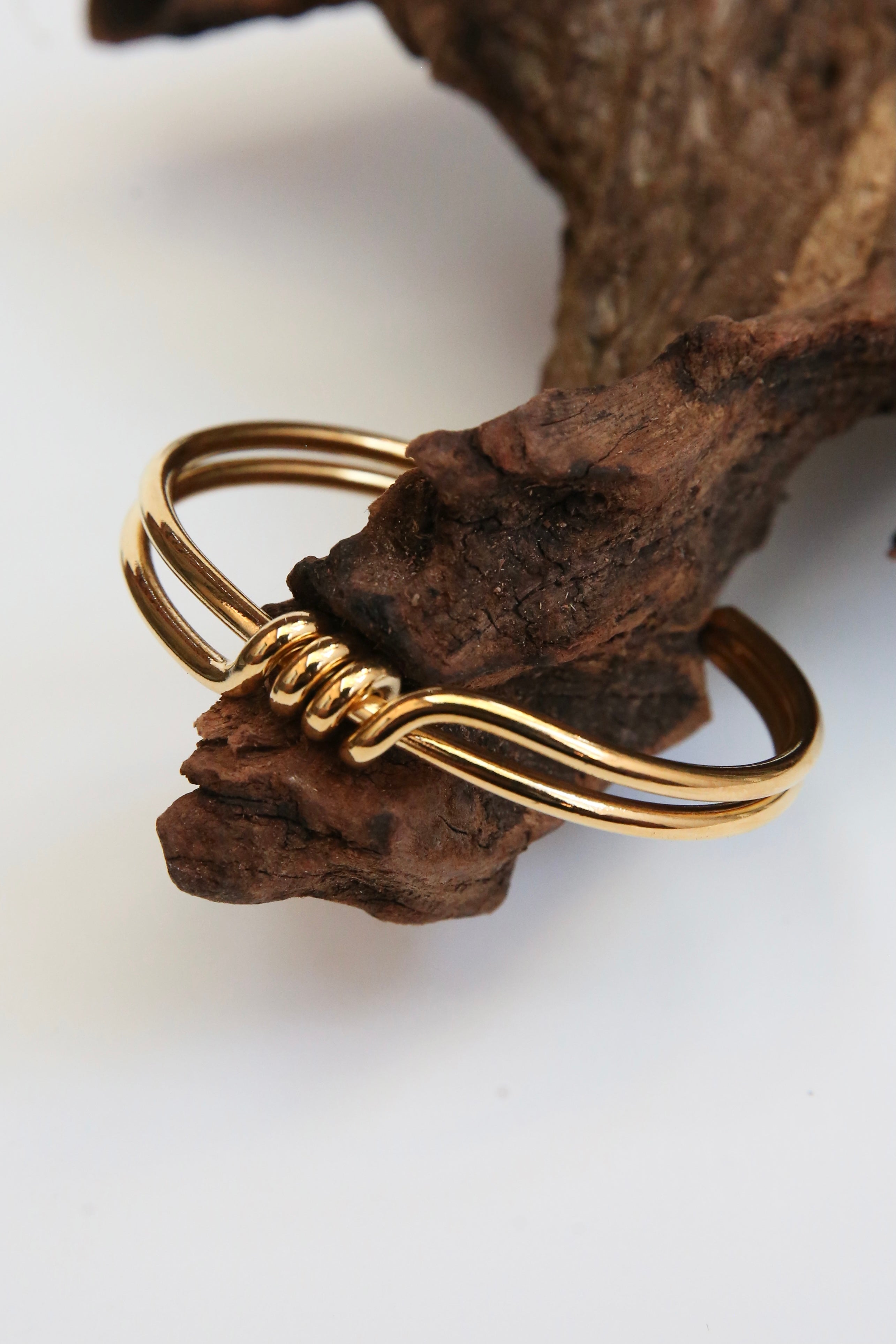 Two banded Gold surrounded bracelet with a front wrap around detail