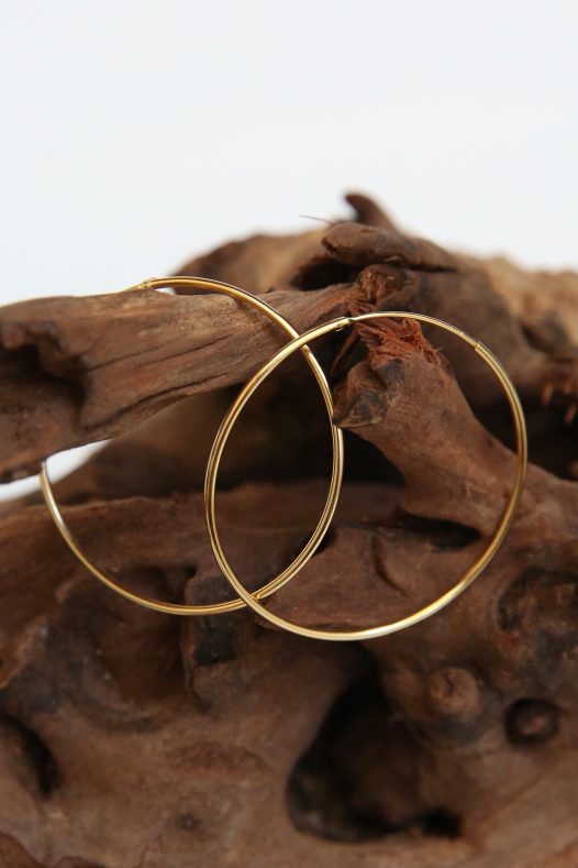14k Amor Deus Gold Classic Hoop Earrings. Solid hoop with an inset and hinge combination closure for a sleek look.