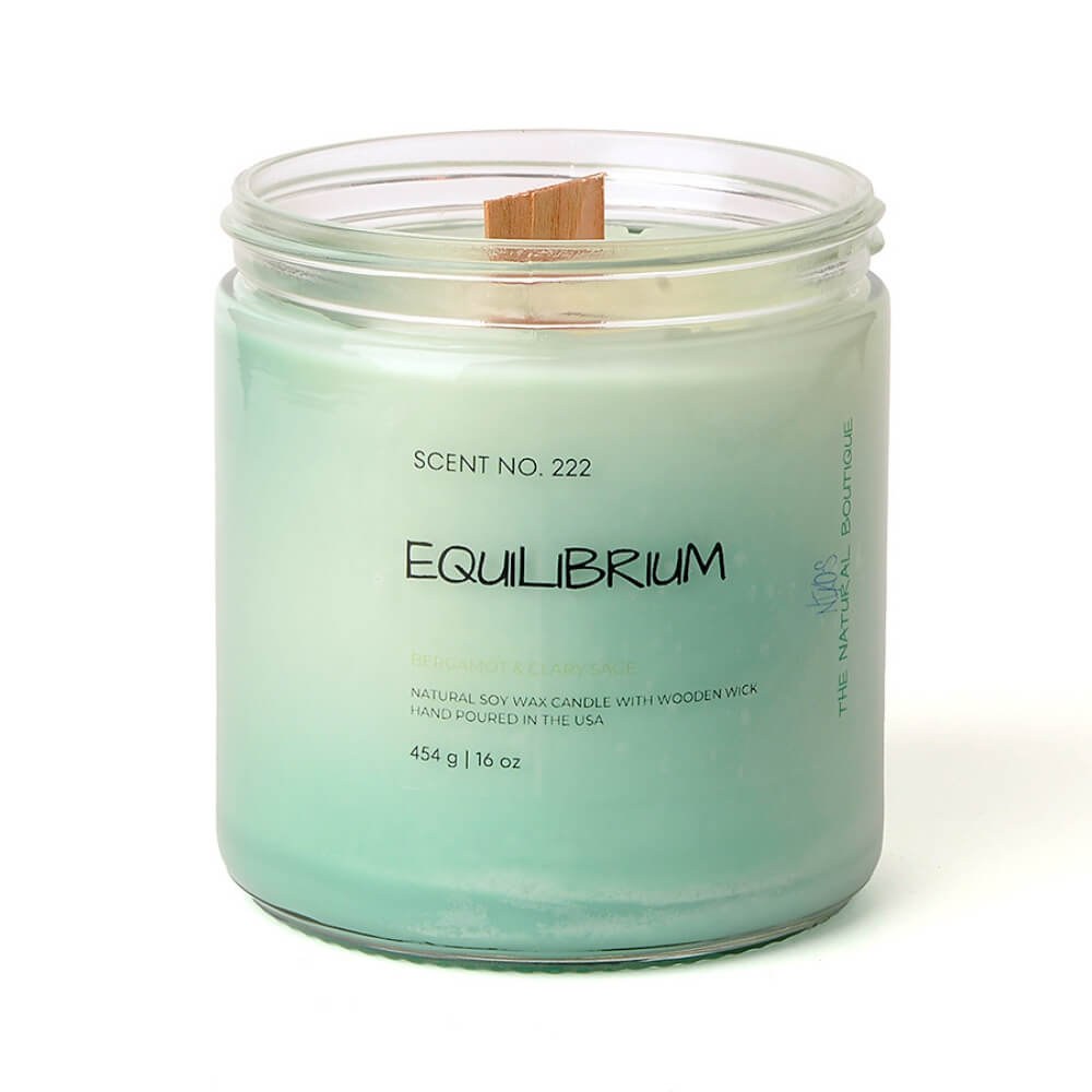 16oz handcrafted soy candle with a wooden wick in a clear glass jar, labeled “Equilibrium,” styled with neutral tones and soft lighting to evoke calm and balance.