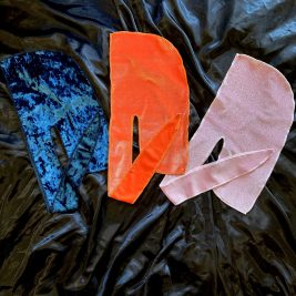 durags on a silk background. crushed blue velvet durag, orange velvet durag, tangerine velvet durag, pink shimmer durag, unisex durag