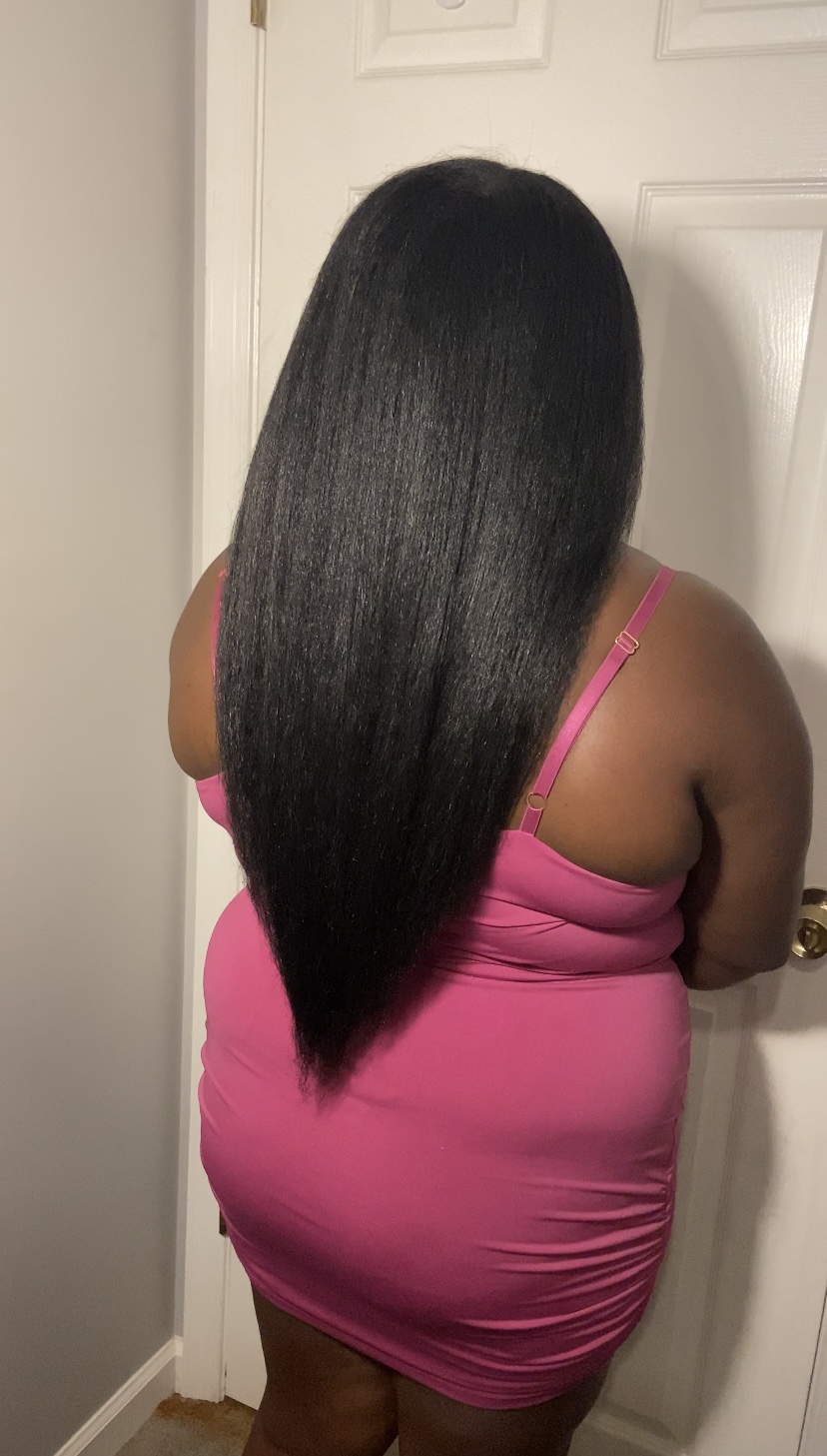 The creator of the Growth Training 101 textbook shows another angle of the length of her natural hair from the back, showing that it reaches her tailbone.